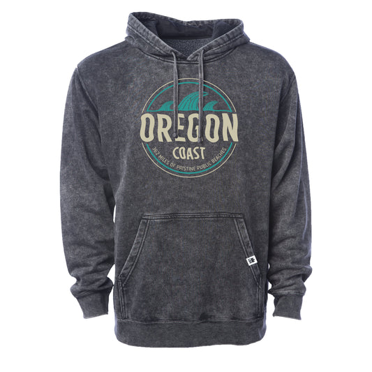 A dark gray acid-wash pullover hoodie with a distressed circular 'Oregon Coast' graphic on the chest, featuring a teal and cream design with a small white tag on the front pocket.